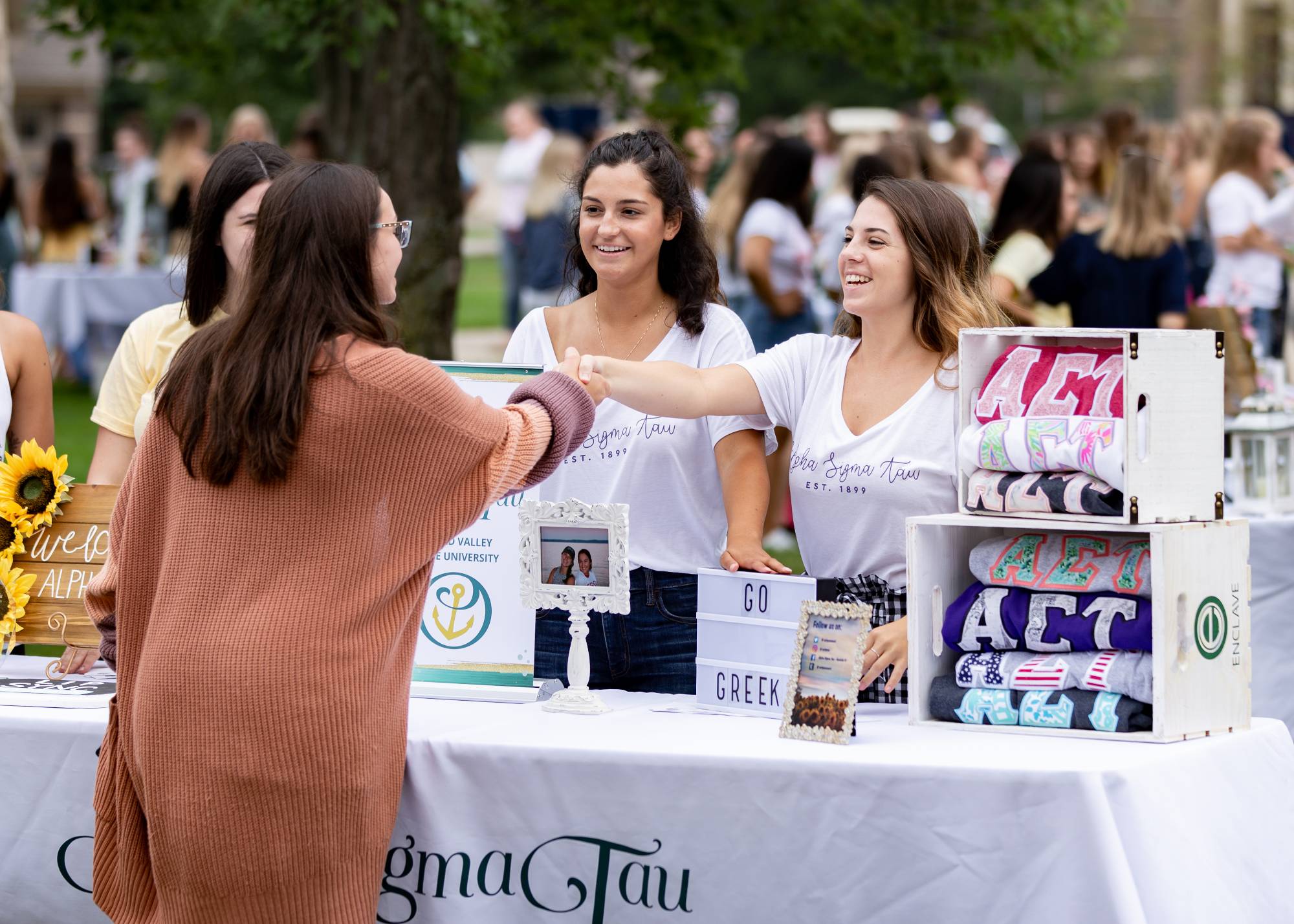 A student at a greek life information booth.